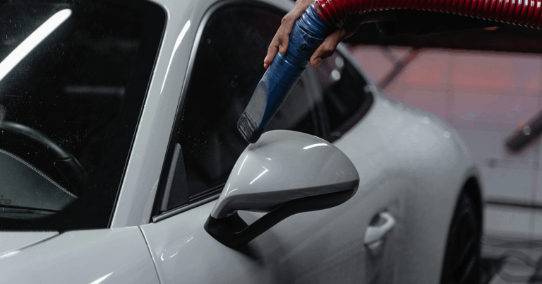 Closeup of technician detailing a car