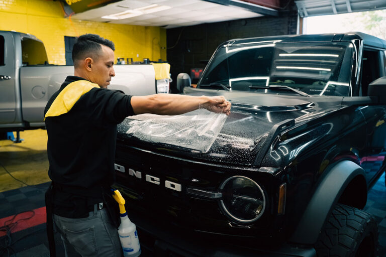 Technician applying protective film