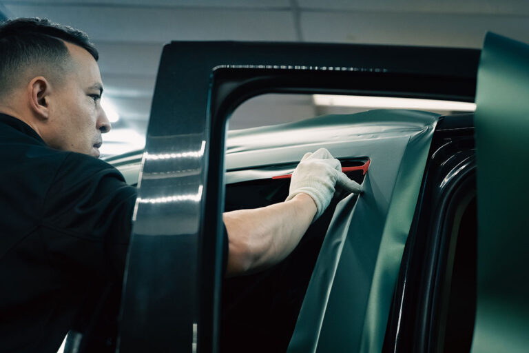 Technician applying car vinyl