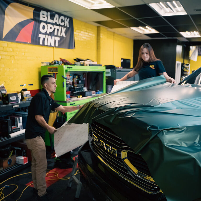 Technicians applying car vinyl