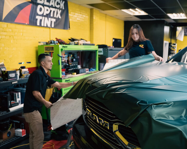 Technicians applying car vinyl