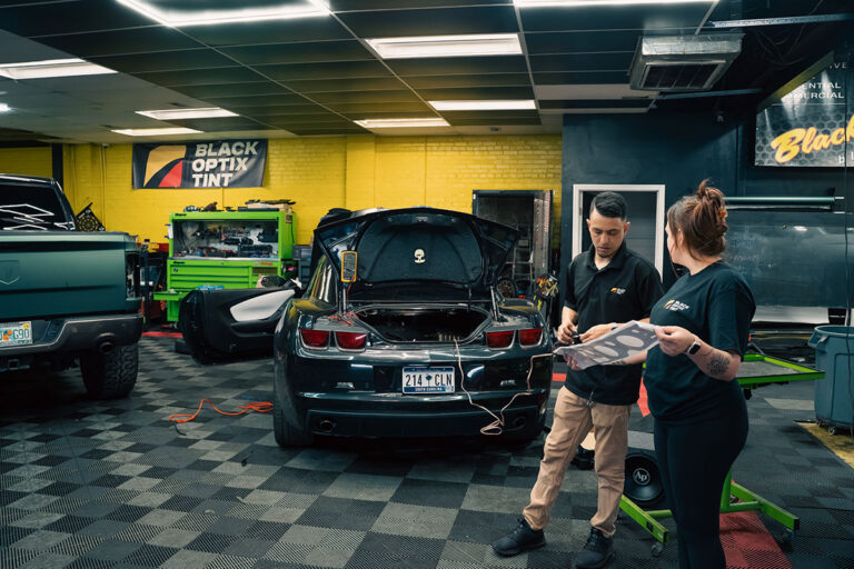 Technicians inside a Black Optix Tint shop