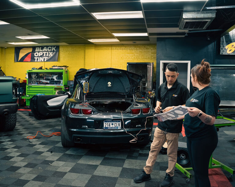Technicians inside a Black Optix Tint shop